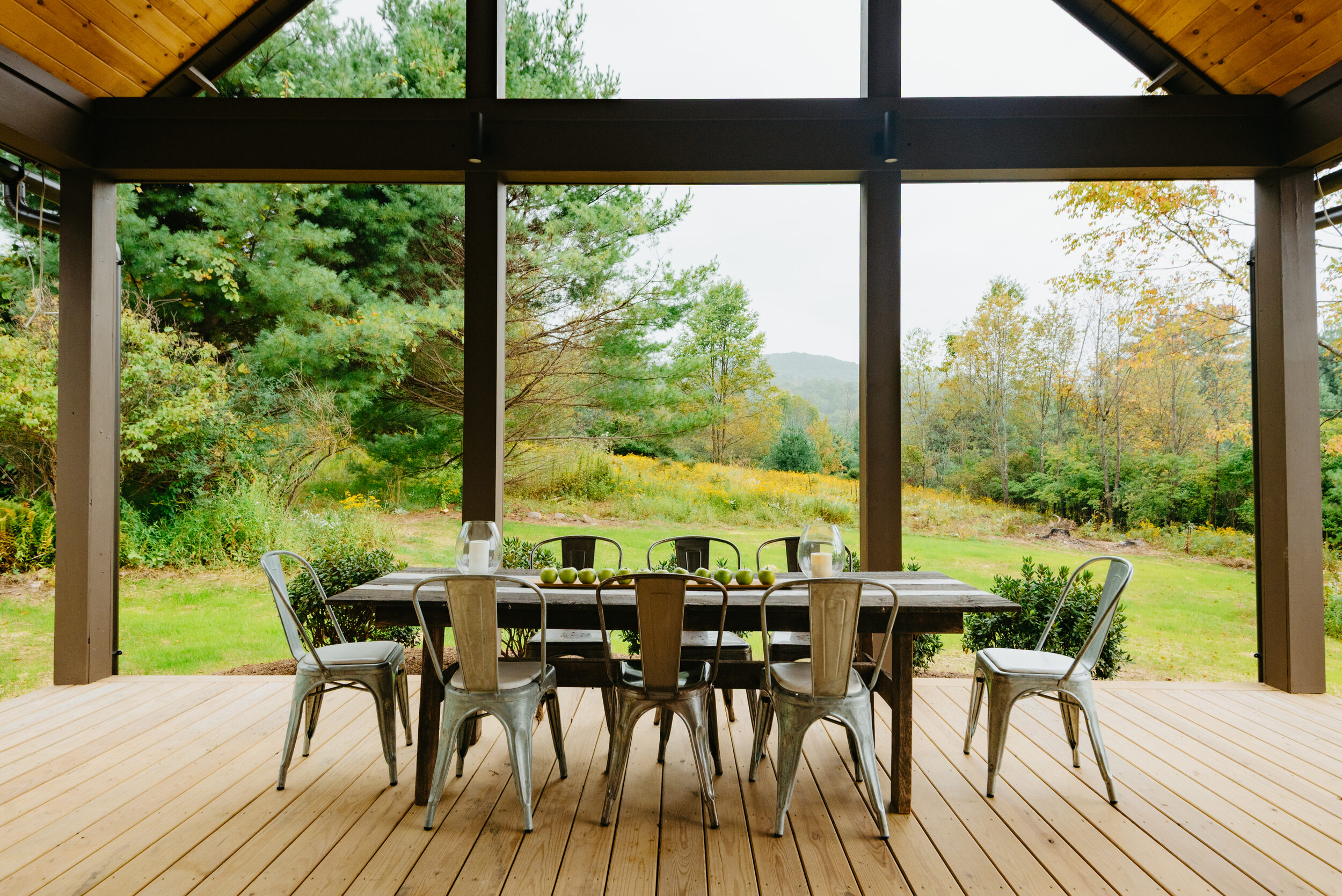 Hemlock House — covered dining porch looking out to the meadow and hills